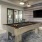 a room with a pool table and a tv and a rug