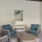 a seating area with blue chairs