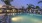 a swimming pool with lounge chairs and a building in a courtyard