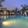 a swimming pool with lounge chairs and a building in a courtyard