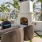 a patio with chairs and a fireplace